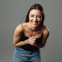 Thumbnail for Smiling woman wearing casual attire, showcasing joy and positivity with a playful pose.
