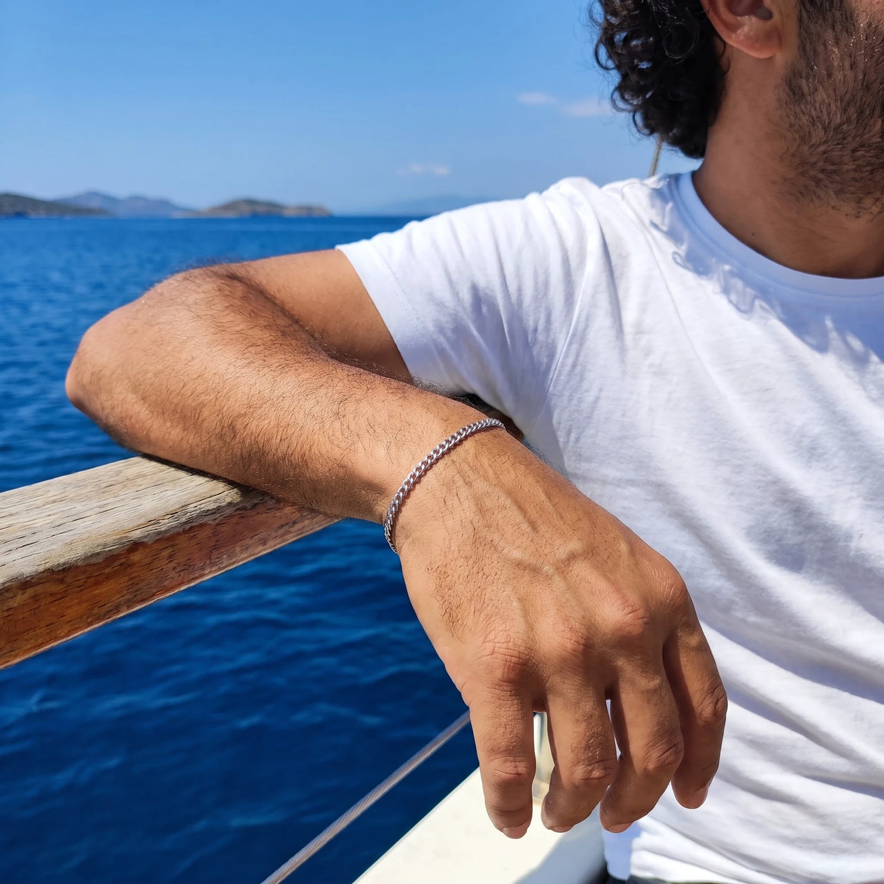 Heart Bond Matching Bracelet Set in Silver — his bracelet worn on a sailing boat