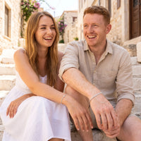 Thumbnail for Heart Bond Matching Bracelet Set in Silver — worn by a couple sitting on sunlit stone steps