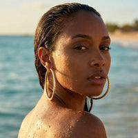 Thumbnail for Diamond Cut Statement Hoops in Gold, worn in the sea, wet skin | SKU: 41009-gold