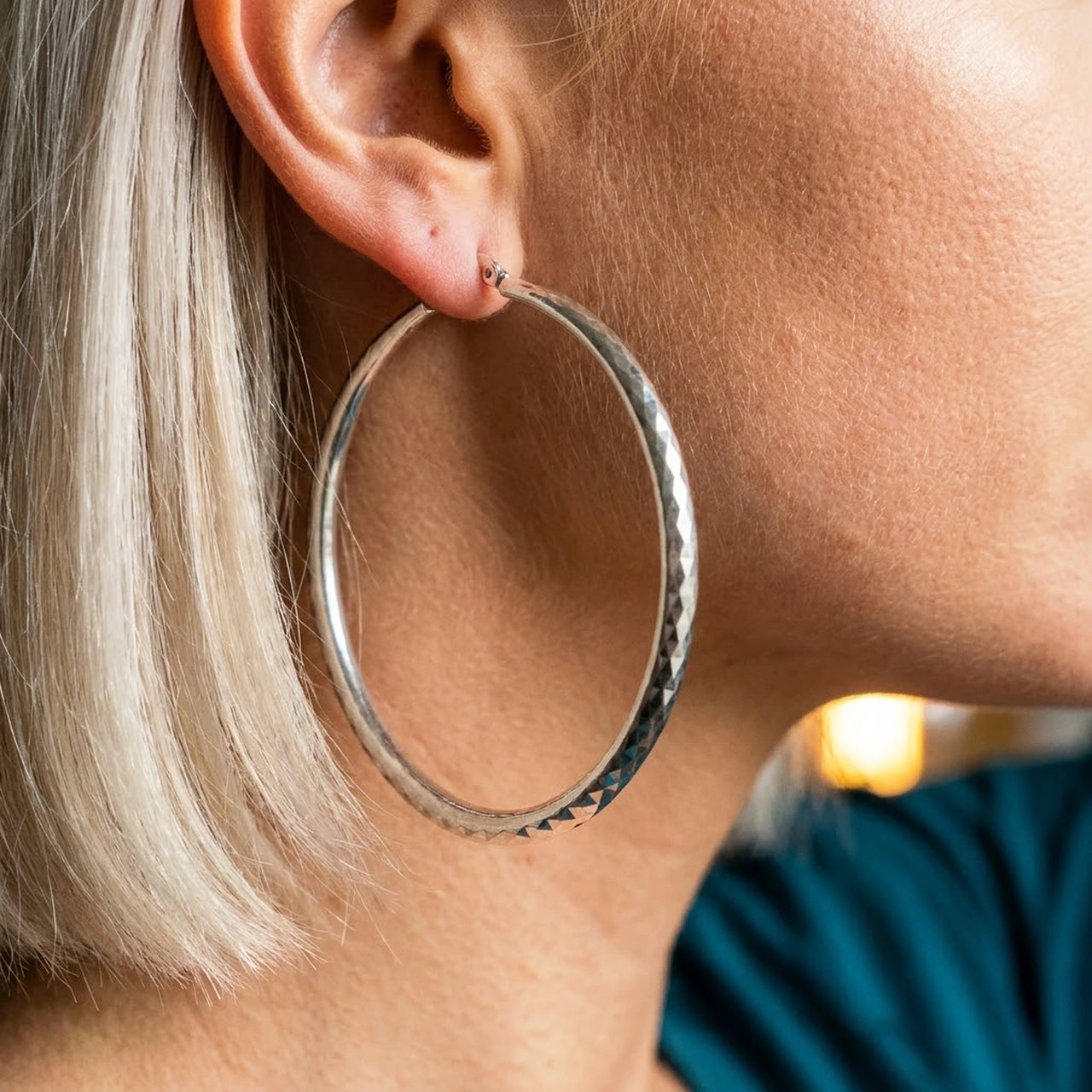 Diamond Cut Statement Hoops in Silver, close-up on the earlobe | SKU: 41009-silver