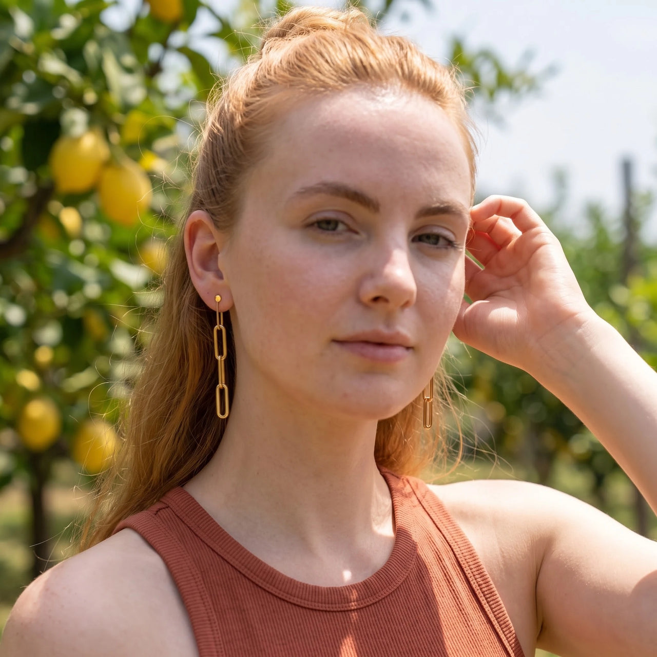 The Pendantes, gold earrings — worn gesture | SKU: lespendantes
