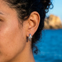 Thumbnail for Pave Cross Huggie Hoops in Silver, close-up on the earlobe | SKU: 41006-silver
