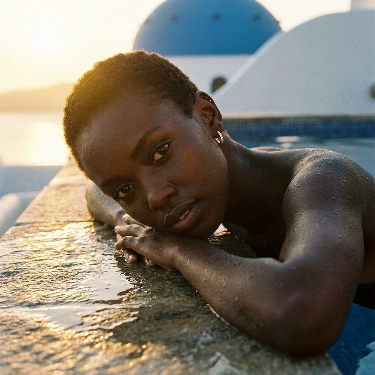 Pave Huggie Hoop Earrings in Gold, worn by a pool in Santorini | SKU: 41011-gold