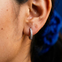 Thumbnail for Pave Huggie Hoop Earrings in Silver, close-up on the earlobe | SKU: 41011-silver