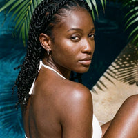 Thumbnail for Pave Huggie Hoop Earrings in Silver, worn by a tropical pool | SKU: 41011-silver