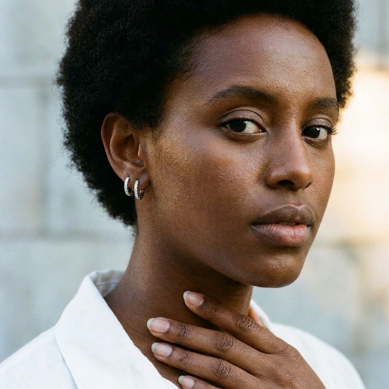 Pave Huggie Hoop Earrings in Silver, worn, close-up | SKU: 41011-silver