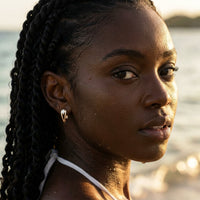 Thumbnail for Pear Crystal Huggie Hoops in Gold, worn in the sea, wet skin | SKU: 41007-gold