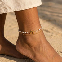 Thumbnail for Pearl Dolphin Anklet Set worn on a sunlit ankle, cream freshwater pearls and a polished gold dolphin charm, by Brother & Sisters.
