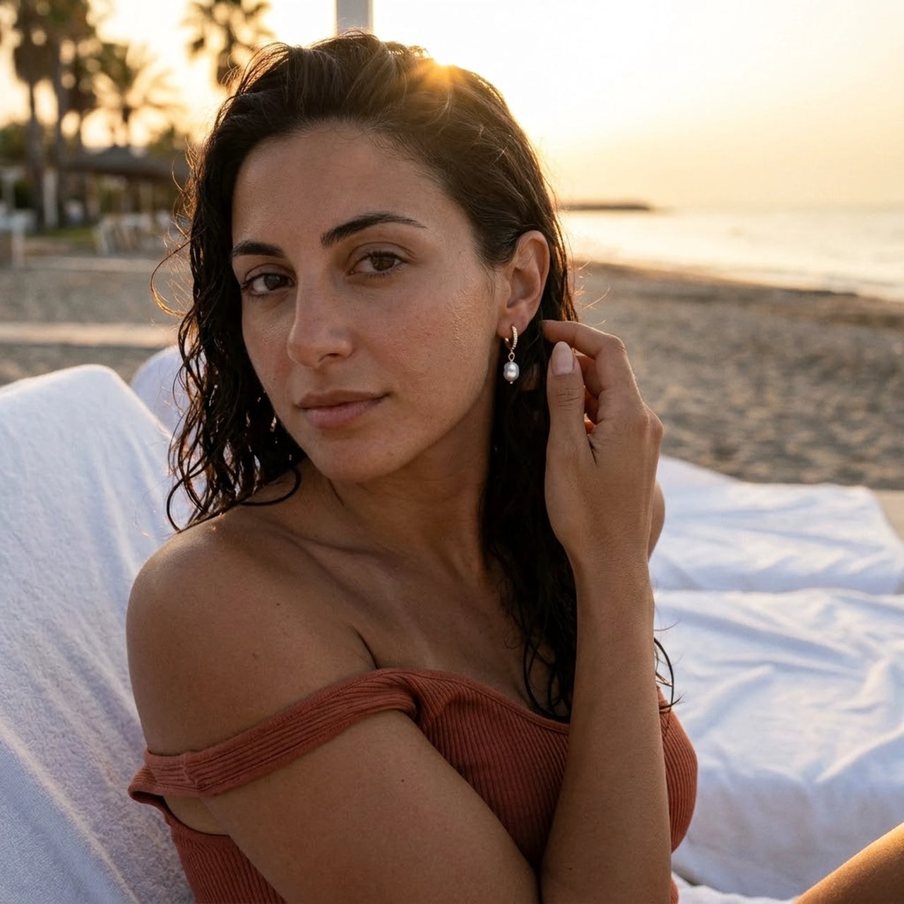 Pearl Drop Huggie Hoops in Gold, worn at a beach club at sunset | SKU: 41003-gold
