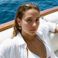 Thumbnail for Pearl Drop Huggie Hoops in Silver, worn on a yacht | SKU: 41003-silver