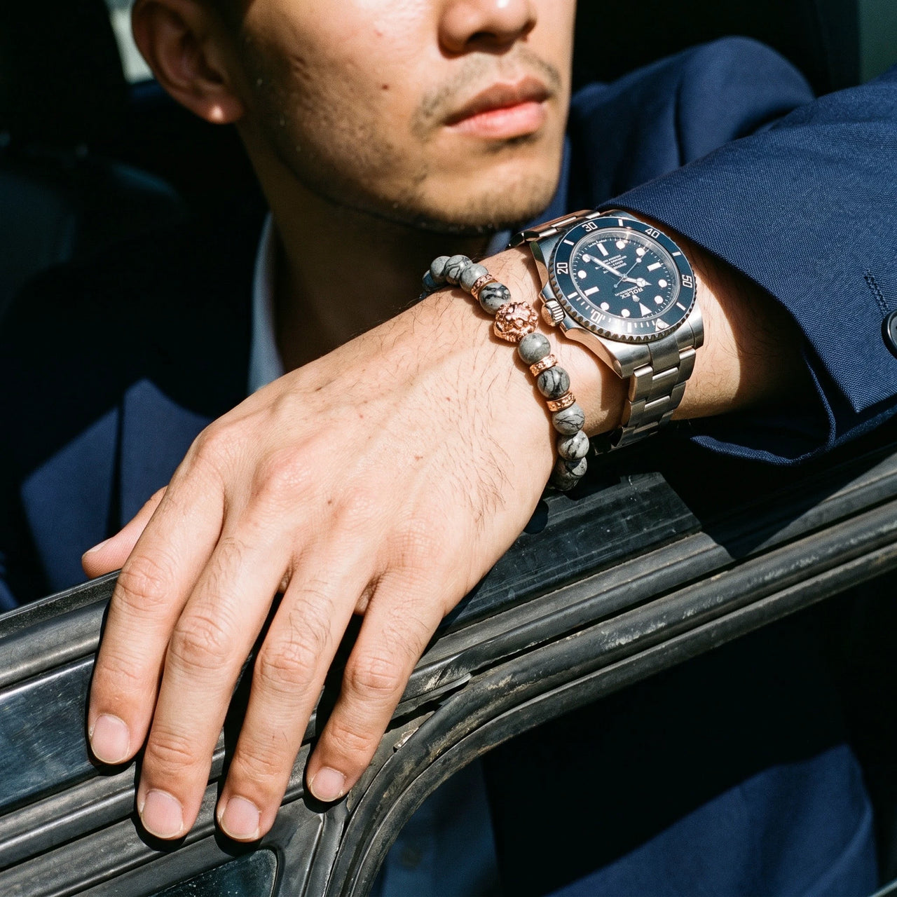 Rose Gold Lion & Grey Stones Bracelet – worn next to a luxury watch | Brother & Sisters | SKU: 20866222-rose-gold-XS-14-15, 20866222-rose-gold-S-16-17, 20866222-rose-gold-M-18-19, 20866222-rose-gold-L-20-21, 20866222-rose-gold-XL-22-23