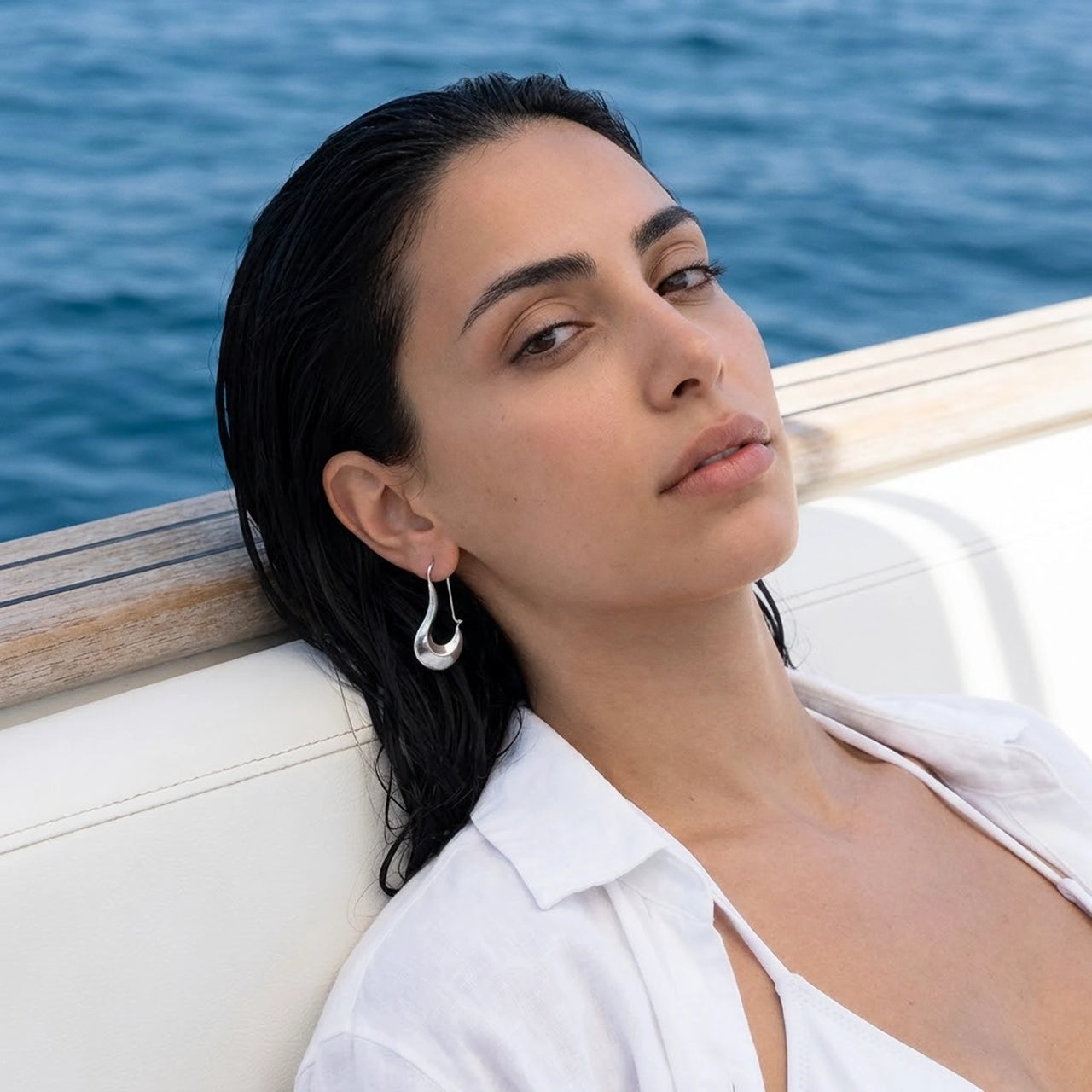 Sculpted Crescent Drops in Silver, worn on a yacht | SKU: 41008-silver