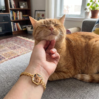 Thumbnail for Customer photo: the gold octagon bracelet with her cat's photo, her cat in the background | SKU: TPH-OCTB-GOLD-18
