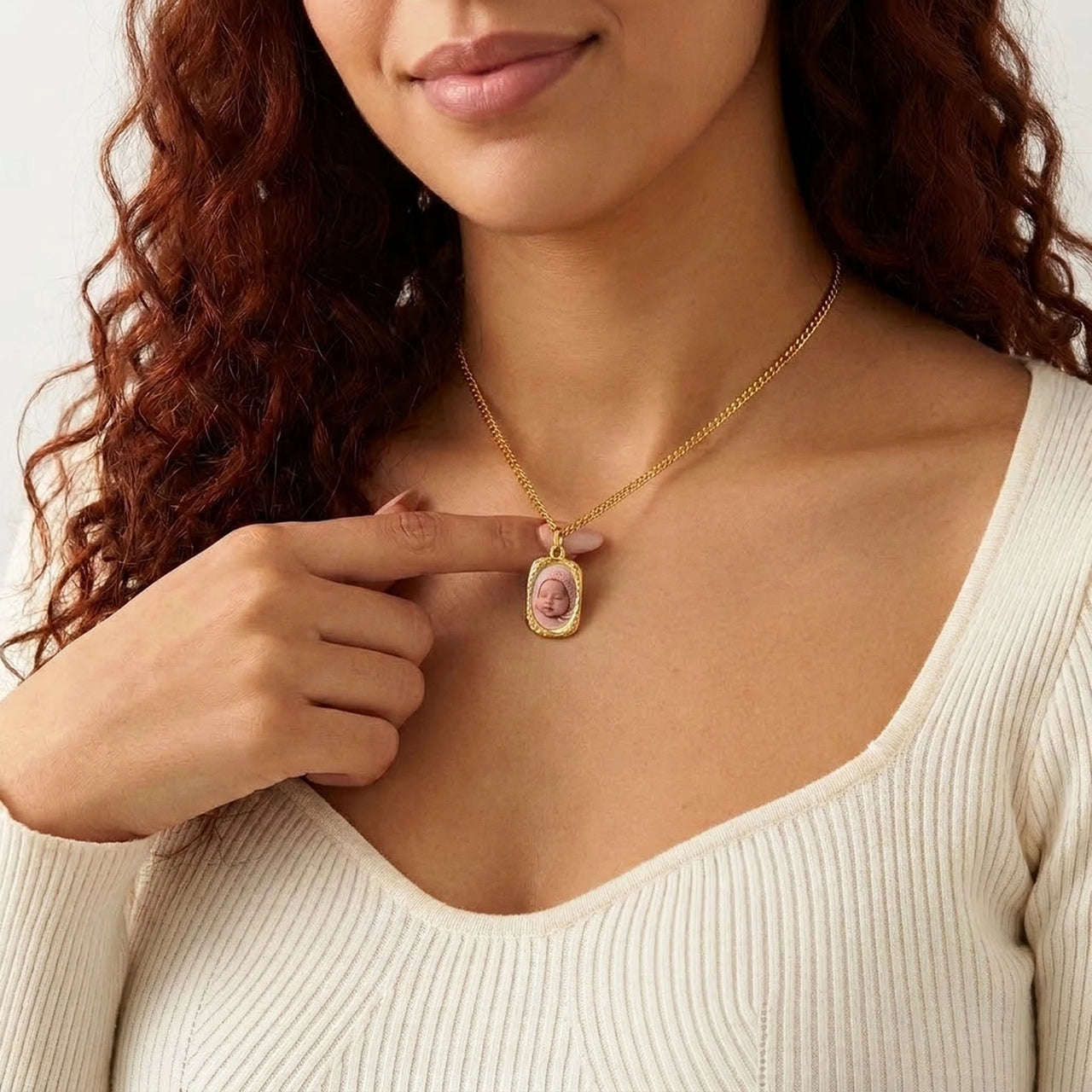 Woman wearing the gold oval photo necklace with her baby's photo | SKU: TPH-OVLN-GOLD