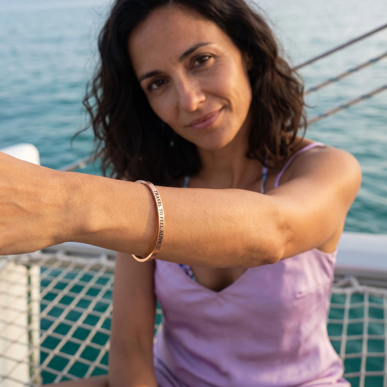 Travel To Feel Alive bracelet in rose gold worn during a relaxed moment | SKU: ttfa-rg