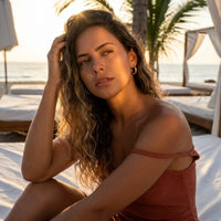 Thumbnail for Twisted Rope Huggie Hoops in Gold, worn at a beach club at sunset | SKU: 41012-gold