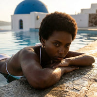 Thumbnail for Twisted Rope Huggie Hoops in Gold, worn by a pool in Santorini | SKU: 41012-gold