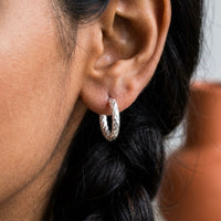 Thumbnail for Twisted Rope Huggie Hoops in Silver, close-up on the earlobe | SKU: 41012-silver