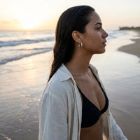 Thumbnail for Twisted Rope Huggie Hoops in Silver, worn on the beach | SKU: 41012-silver